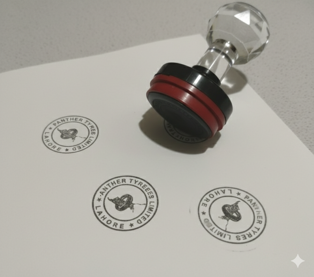 Flashstamp with Diomond handle and red and black design on a white surface with printed stamps.