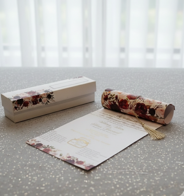 Floral-themed Scroll Wedding Cards with a box, paper, and roll on a textured surface.