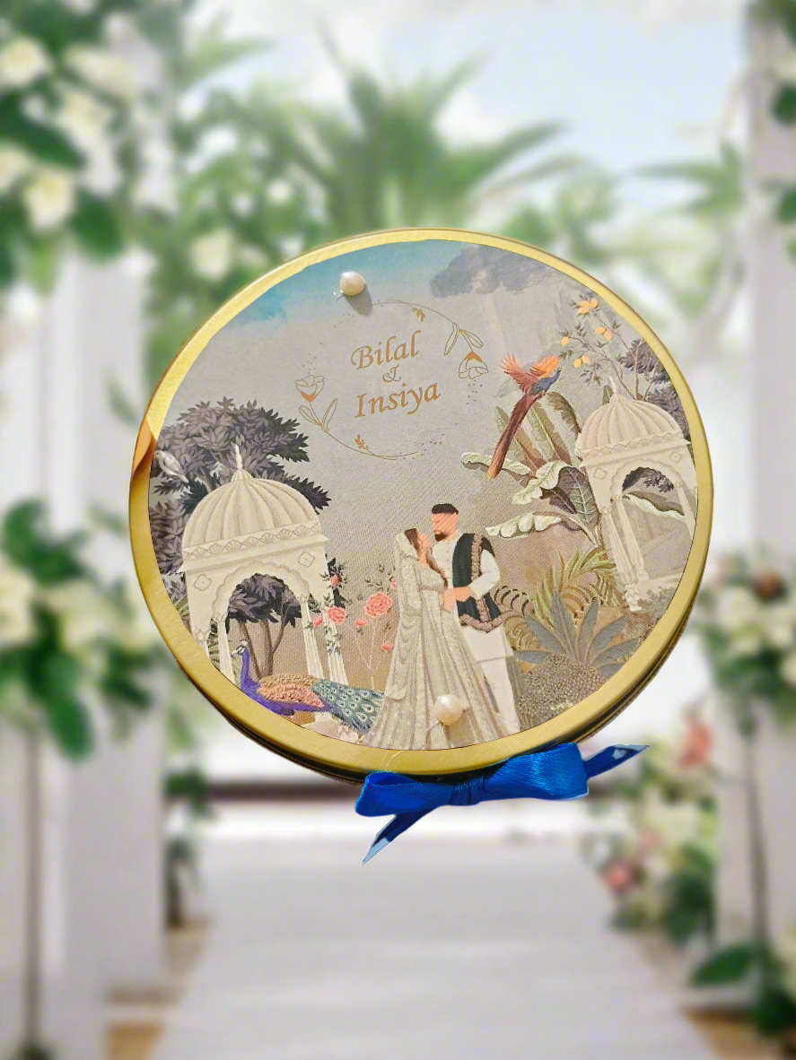 A round tin box with a customized name printing, featuring a couple, trees, and decorative elements in a garden setting.