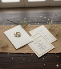 This image presents a sophisticated collection of wedding invitations for the year 2026. The invitations are designed with an elegant white and gold color scheme, featuring detailed gold framing around the text.