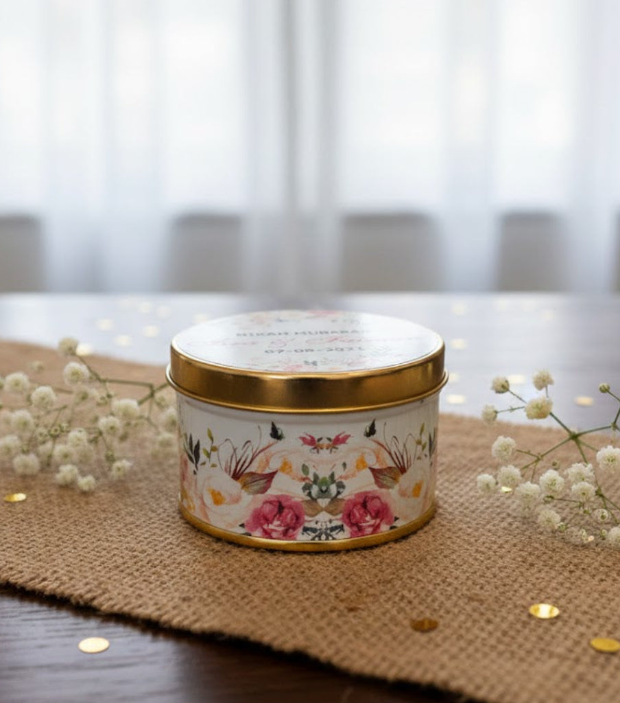 Decorative  tin bid box  with floral design on a table with a burlap runner and white flowers.