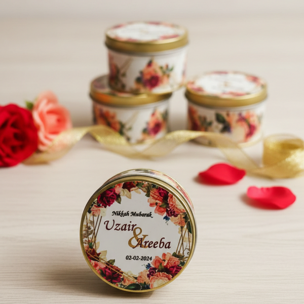 Decorative candles with floral designs and personalized text on a neutral background