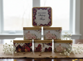 Customized square tin box with floral pattern and customized name printing.